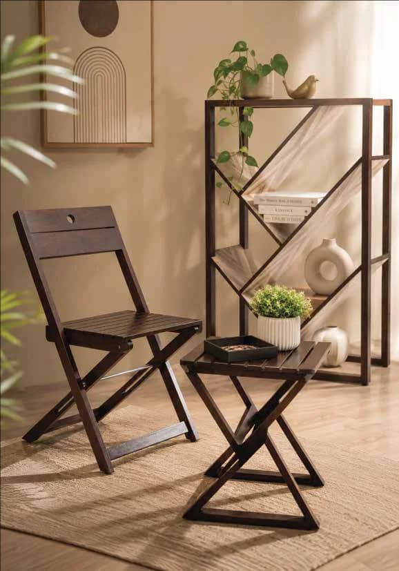 A folding chair and nesting side table beside a shelf